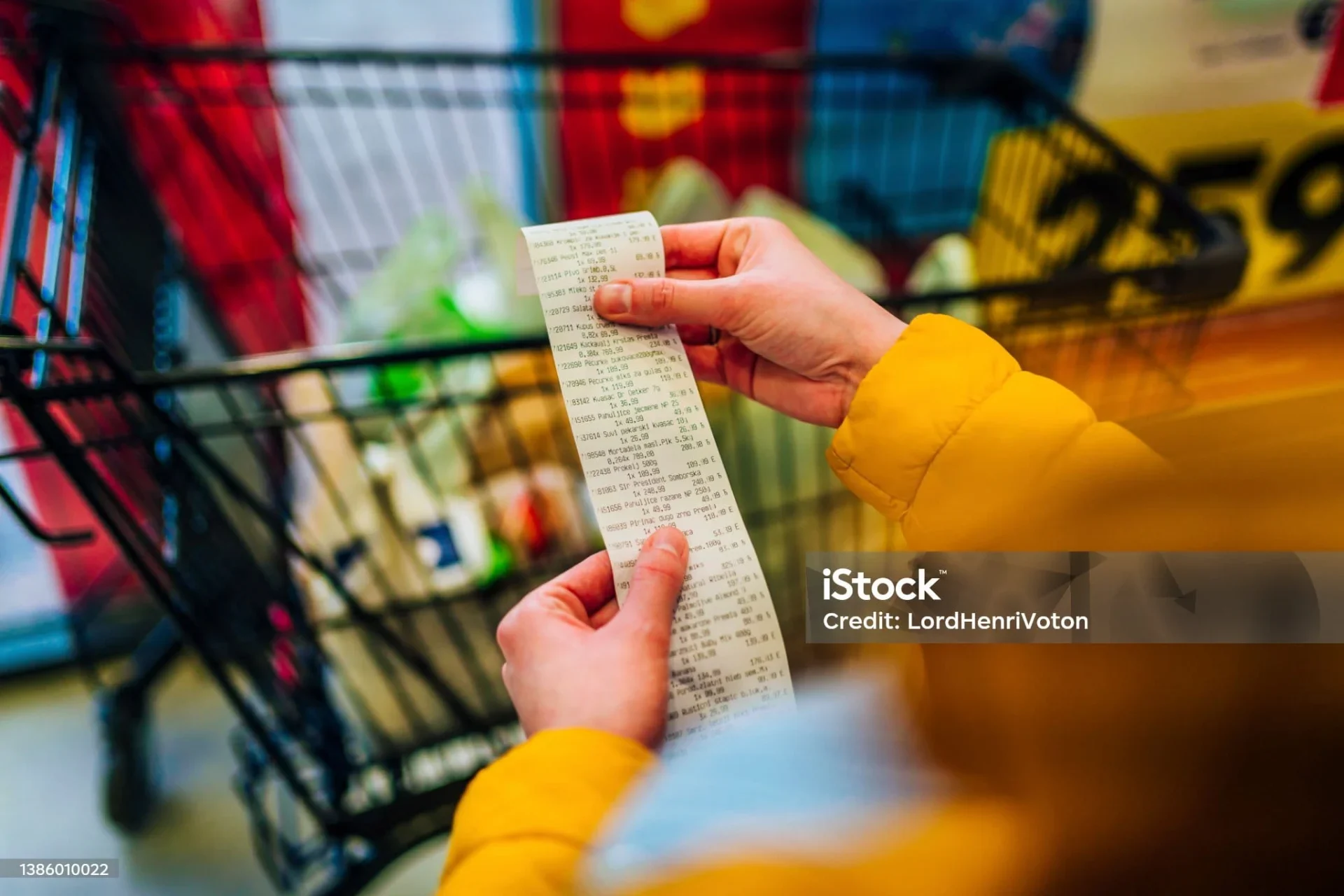 Woman Checking The Bill When Paying At A Supermarket