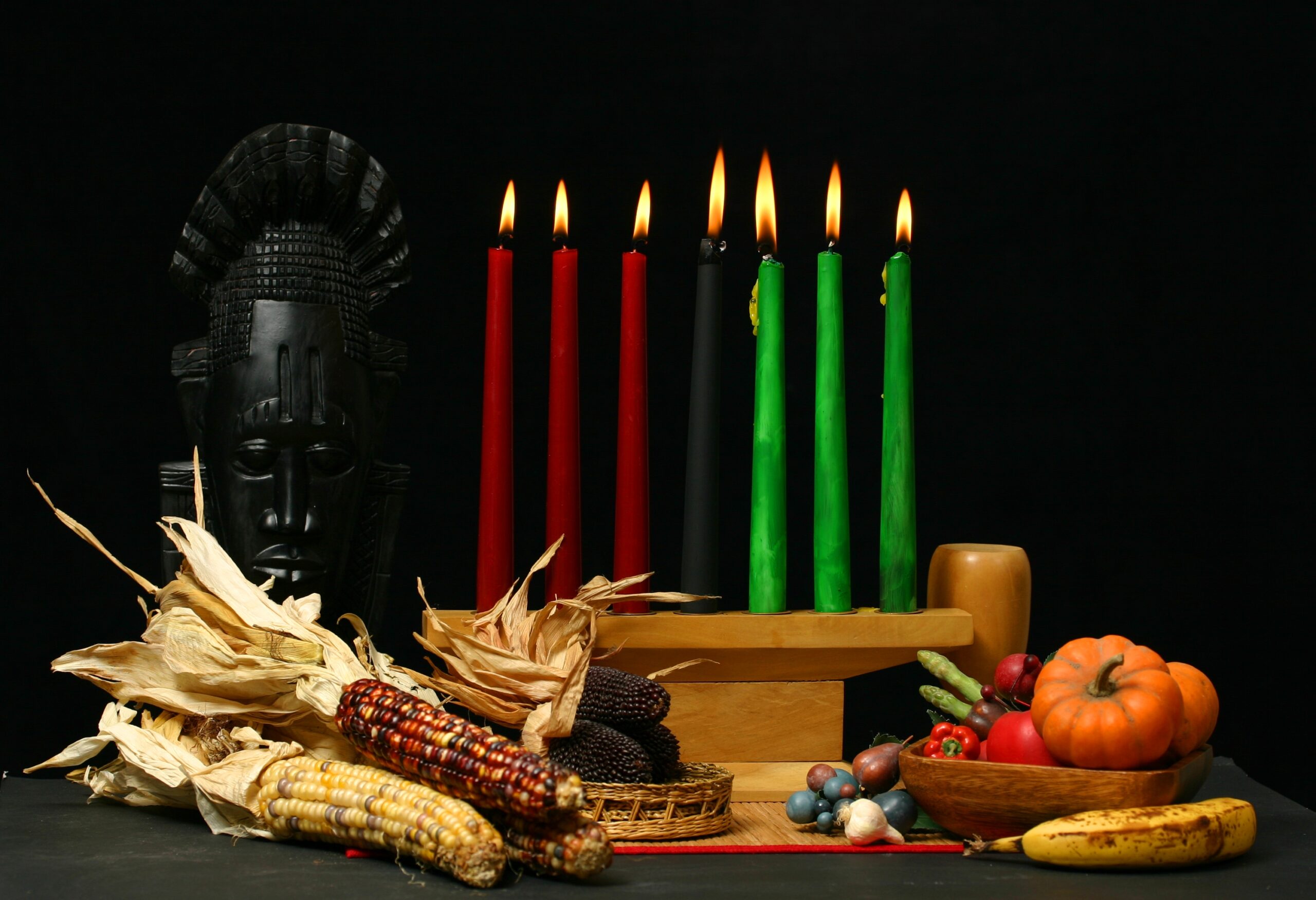 Kwanzaa Table Setting With Candle And Dried Corn Cobs